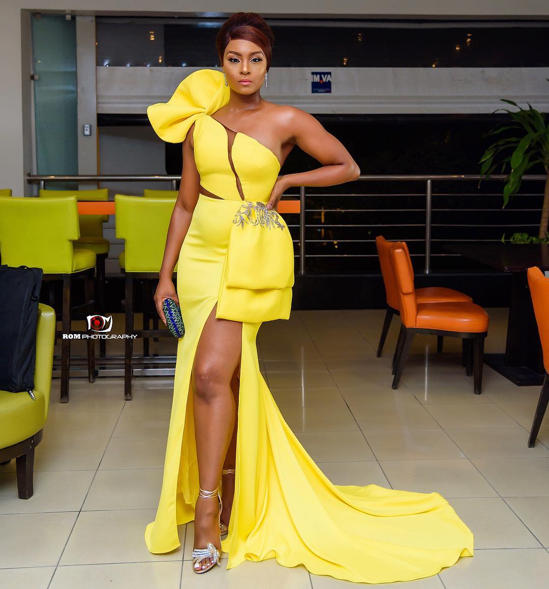 Osas Ighodaro Ajibade dressed in a yellow dinner gown